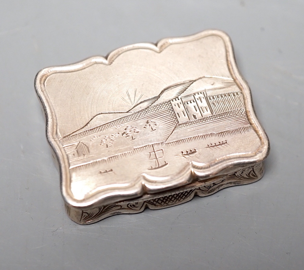 A Victorian silver shaped rectangular vinaigrette, engraved with landscape scene with river, Edward Smith, Birmingham, 1847, 38mm.